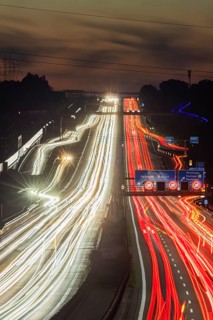 Motorway near Stuttgart with several lanes in the evening with sunset. Heavy traffic with light
