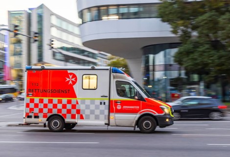 Ambulance of the BOS organisation Johanniter in an urban environment. Pull along. Stuttgart,