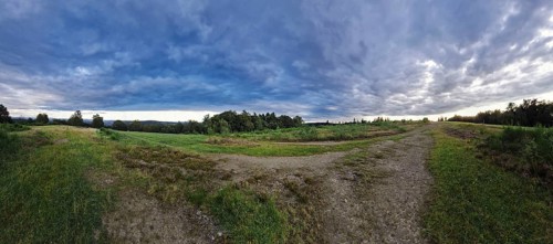 Vast landscape with dramatic clouds and a meandering path. Heaths and rough grassland nature