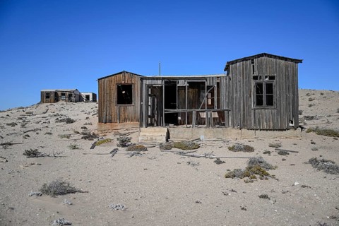 Dilapidated building in the desert sand, Pomona, restricted diamond area, near Lüderitz, Karas