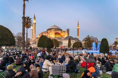 Muslims at an evening Ramadan picnic in the park in front of the Hagia Sophia mosque in Istanbul,
