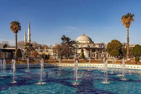 Fountain in Sultan Ahmet Park and the Sultanahmet Madrasa in Istanbul, Turkey