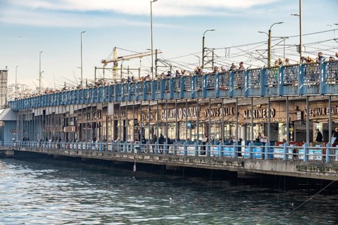 Anglers and restaurants on the Galata Bridge in Istanbul, Turkey