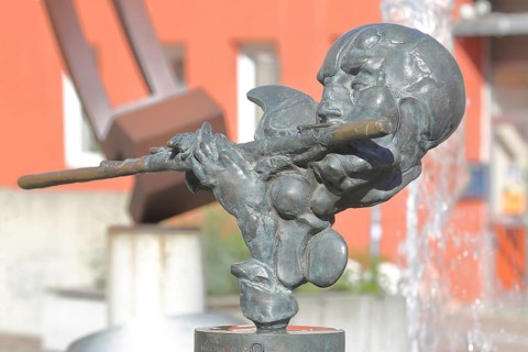 Sculpture Flute Player by Karel Fron 2008, bronze sculpture, modern art, bizarre head with flute,