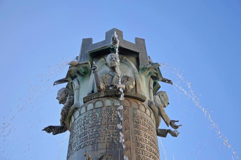 Town hall fountain by Klaus Ringwald 1998, bronze sculptures, reliefs, figures and text on the