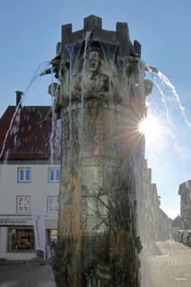 Town hall fountain with reliefs and figures by Klaus Ringwald 1998 in backlight, bronze sculptures,