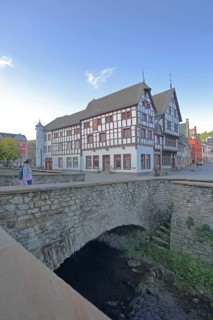 Heinz-Küpper-Bridge over the Erft stream and half-timbered house, pedestrian, stone arch bridge,