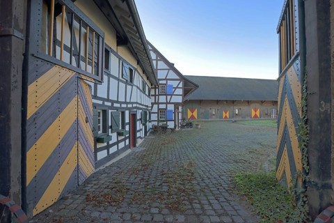 Portal and half-timbered house with colourful shutters, built 14th century, inner courtyard,