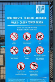 Posted rules sign with pictograms showing various restrictions at Clock Tower Beach, Old Port of