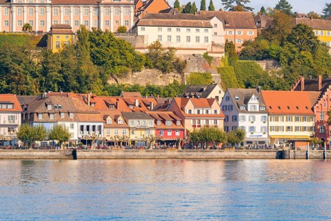 Historic row of houses on the lake with colourful architecture and autumnal trees, Meersburg, Lake