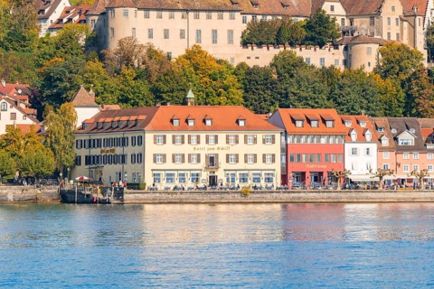 Historic buildings on the lakeshore with autumnal vegetation in the background, Meersburg, Lake