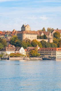 Castle and historic buildings on the lake, hills and autumn colours, Meersburg, Lake Constance,