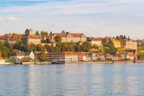 Historic buildings on the shore of a lake, surrounded by hills, Meersburg, Lake Constance, Germany