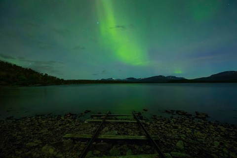 Magical northern lights over Lake Torneträsk at the boathouse