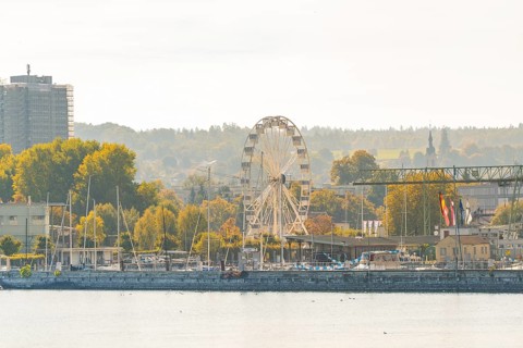 Harbour panorama with Ferris wheel and autumnal trees under a clear sky, Constance, Lake Constance,