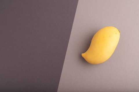 Orange mango on black and gray paper pastel background. Top view, flat lay, copy space. healthy