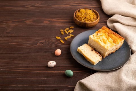 ?ottage cheese ?asserole, Curd cake, with dried apricots and raisins on brown wooden background and