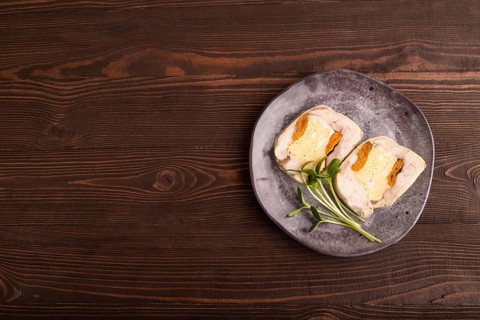 Chicken, egg and dried apricot meatloaf, microgreen on brown wooden. Diet, healthy eating. top