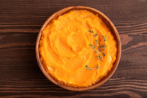 Sweet potato porridge in wooden bowl on wooden background. Diet, healthy eating concept. top view,