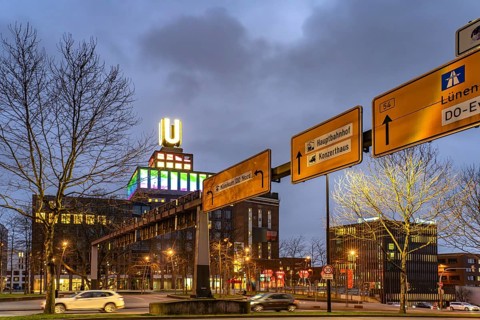 Traffic signs at Wallring and Dortmund's landmark U, Centre for Art and Creativity at dusk,
