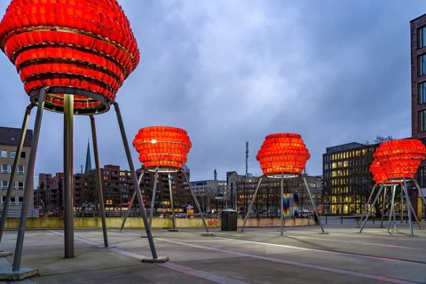 Illuminated sculptures of Dortmund roses in front of Dortmund's landmark U at dusk, Dortmund, North