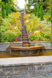 Stepped waterfall in the middle of a flowering garden with colourful plants, Mainau Island, Lake