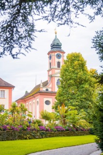 Historic church with beautiful garden in the foreground, Mainau flower island, Lake Constance,