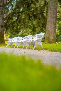 Quiet scenery with white benches in a park, Mainau flower island, Lake Constance, Germany