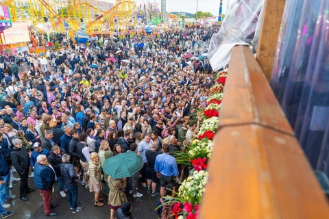 Large crowds at a colourful festival with a cheerful atmosphere, Cannstatter Wasen folk festival,