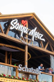 Wooden balcony with lettering in the evening mood and festive lighting, Cannstatter Wasen folk