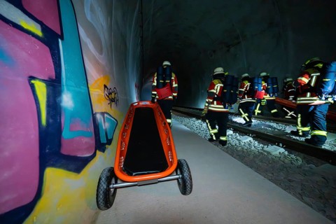 Firefighters pushing a stretcher in a tunnel with graffiti, firefighting exercise in the new