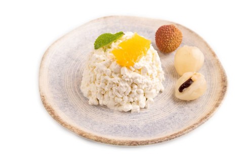 White ?ottage cheese, Curd, with orange and lychee isolated on white background, side view, close