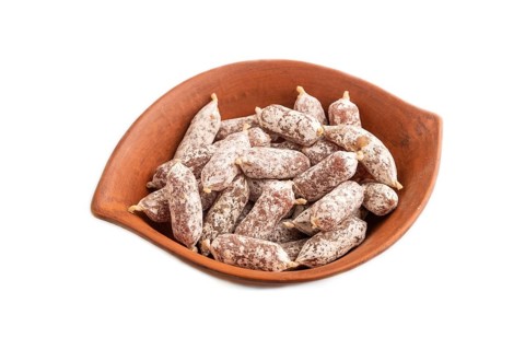 Small smoked Chicken sausages in clay bowl isolated on white background. side view, close up