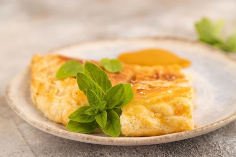 Fried homemade Khachapuri cake with cheese and meat, fried in pan. Traditional Georgian cuisine on