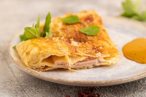 Fried homemade Khachapuri cake with cheese and meat, fried in pan. Traditional Georgian cuisine on