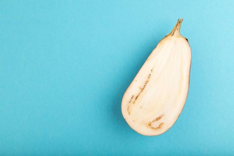 Purple Cutted eggplant on blue pastel background. Top view, flat lay, copy space. Tropical, healthy