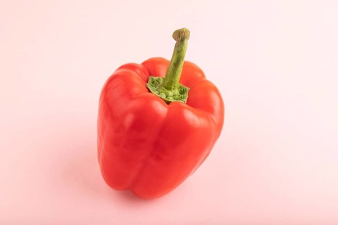 Red pepper on pink pastel background. Side view, copy space. healthy food, vegetable, minimalism