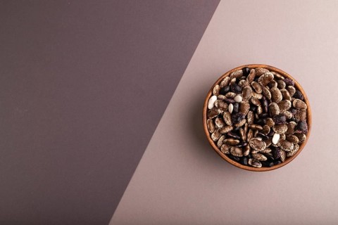 Wooden bowl with Kidney beans on beige and gray pastel paper background, top view, flat lay, copy
