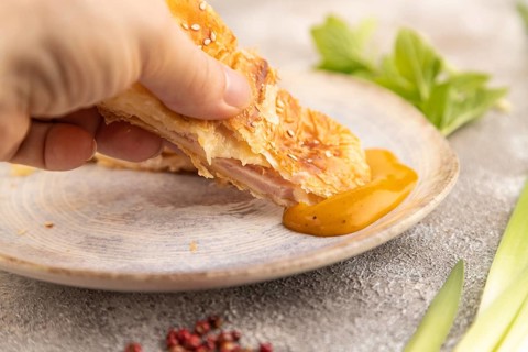 Fried homemade Khachapuri cake with hand with cheese and meat, fried in pan. Traditional Georgian