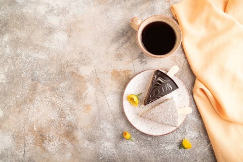 Chocolate and Vanilla Cake pops Marshmallow with cup of coffee on brown concrete background and