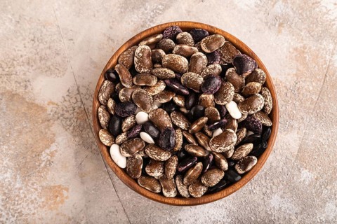Wooden bowl with Kidney beans on brown concrete background, top view, flat lay, copy space,