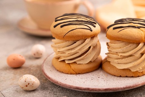 Caramel Cream Cakes on brown concrete background, cup of coffee, side view, close up, selective