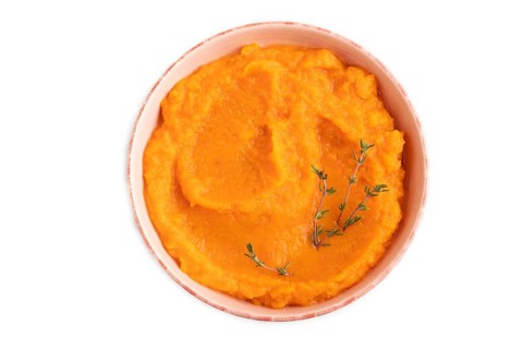 Sweet potato porridge in ceramic bowl isolated on white background. Diet, healthy eating concept.