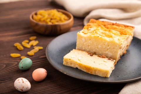 ?ottage cheese ?asserole, Curd cake, with dried apricots and raisins on brown wooden background and