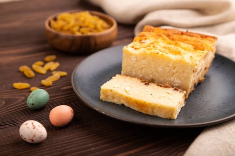 ?ottage cheese ?asserole, Curd cake, with dried apricots and raisins on brown wooden background and