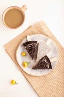 Chocolate and Vanilla Cake pops Marshmallow with cup of coffee on white wooden background and beige