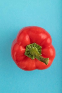 Red pepper on blue pastel background. Top view, flat lay, copy space. healthy food, vegetable,