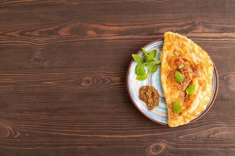 Fried homemade Khachapuri cake with cheese and meat, fried in pan. Traditional Georgian cuisine on