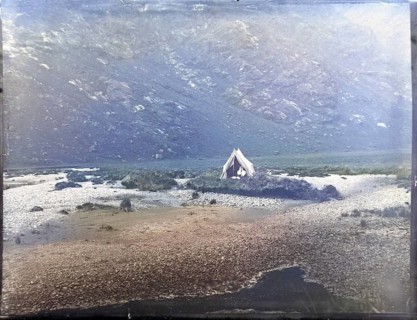 Tent camp on island in river of mountain valley, thought to be Cuillin mountains, Skye, Scotland,
