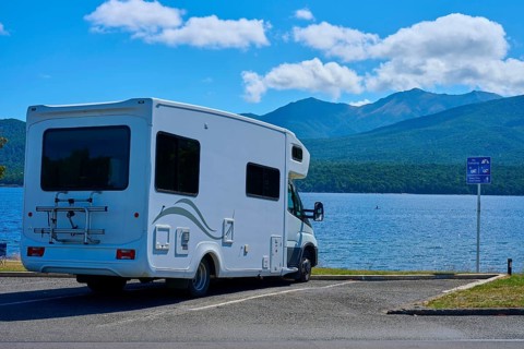 Motorhome in a car park overlooking a tranquil lake and mountains, Te Anau, Lake Te Anau, Southland
